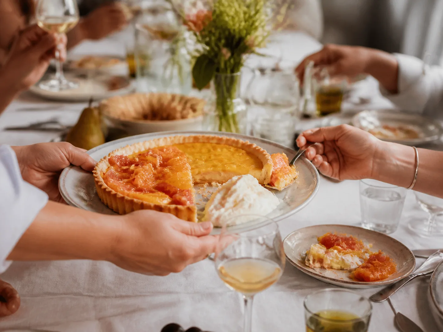Citrus tart served across a communal table