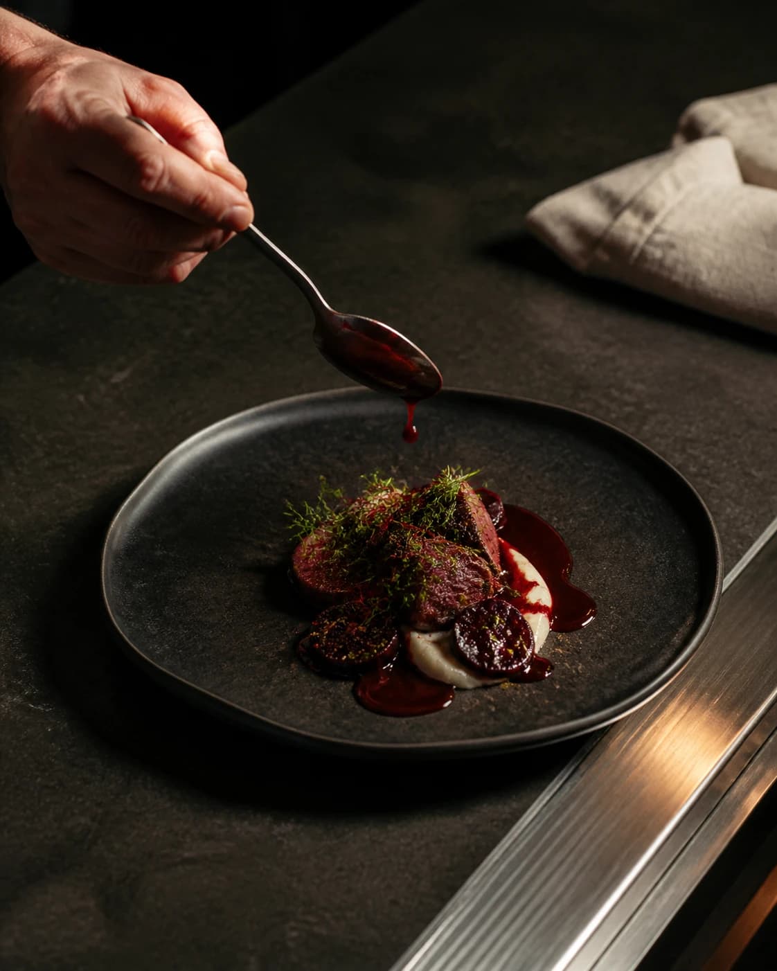 Chef finishing a plated seasonal dish