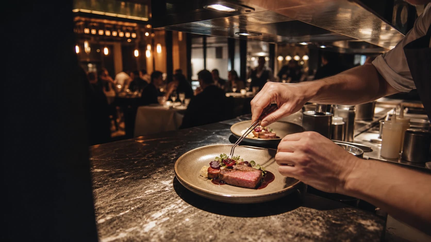 Chef plating during a busy evening restaurant service